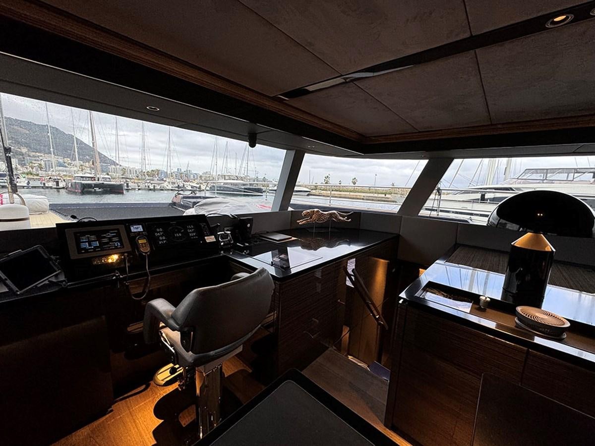 a room with a desk and chairs aboard NAOMA Yacht for Sale