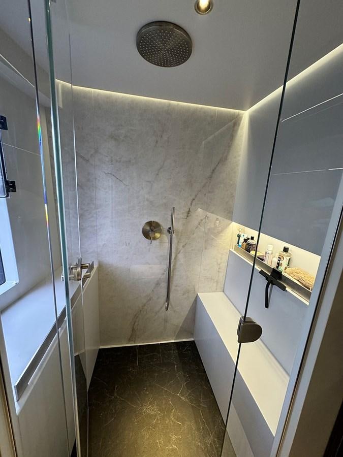 a bathroom with a glass shower aboard NAOMA Yacht for Sale