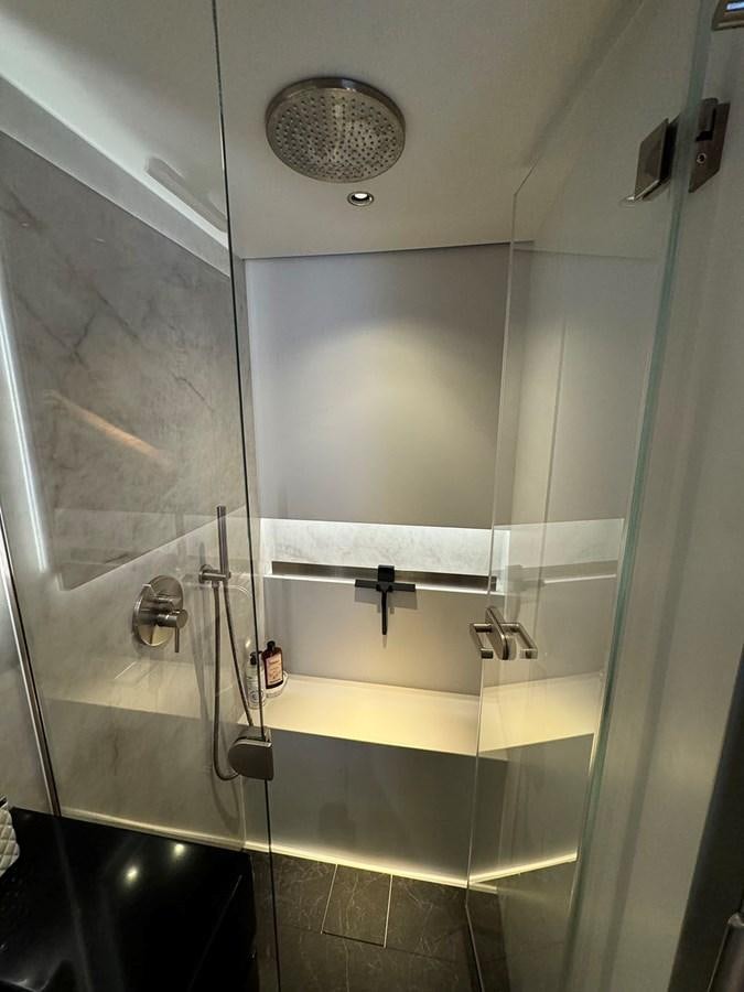 a bathroom with a glass shower aboard NAOMA Yacht for Sale