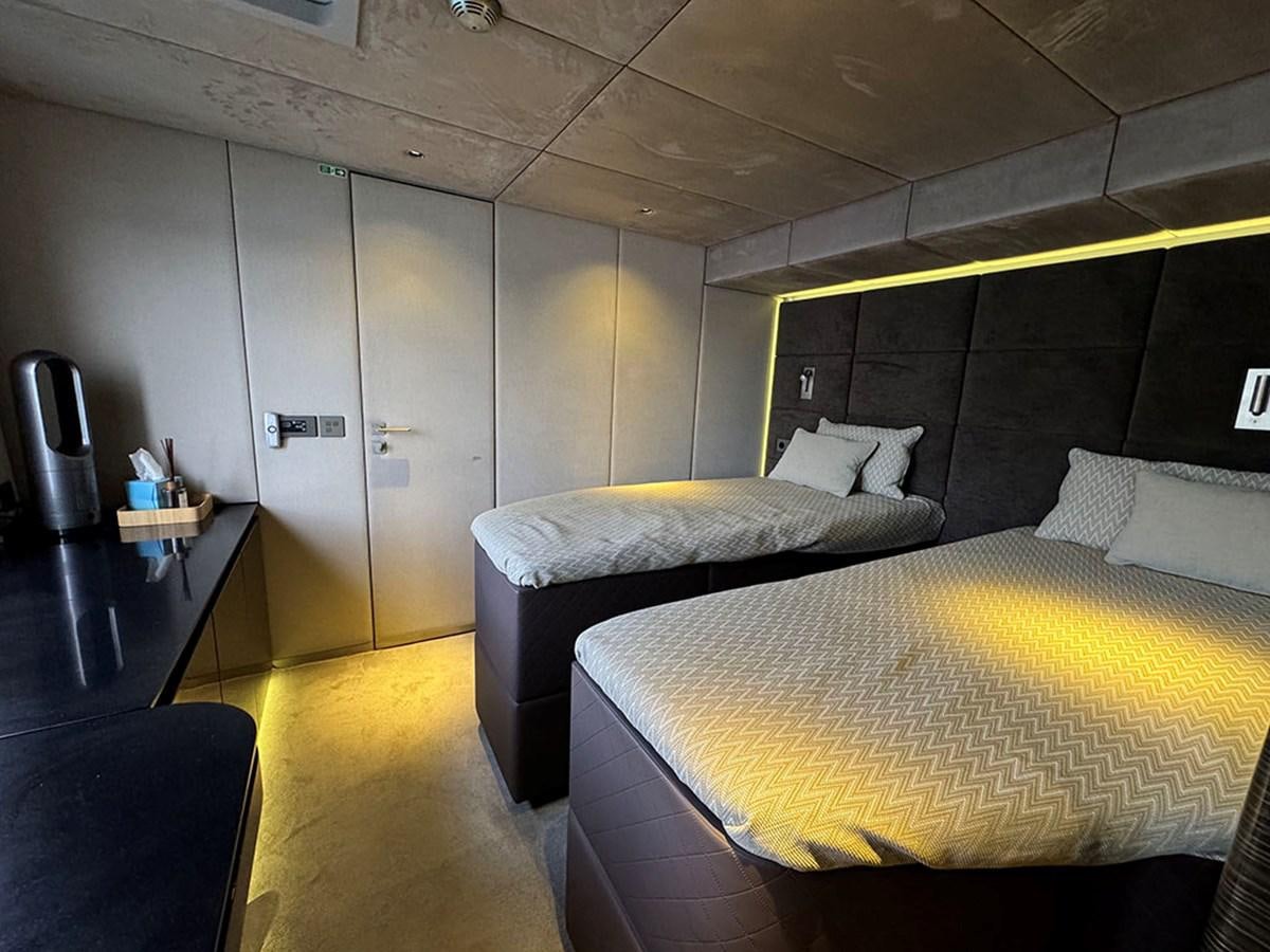 a room with a bed and a desk aboard NAOMA Yacht for Sale