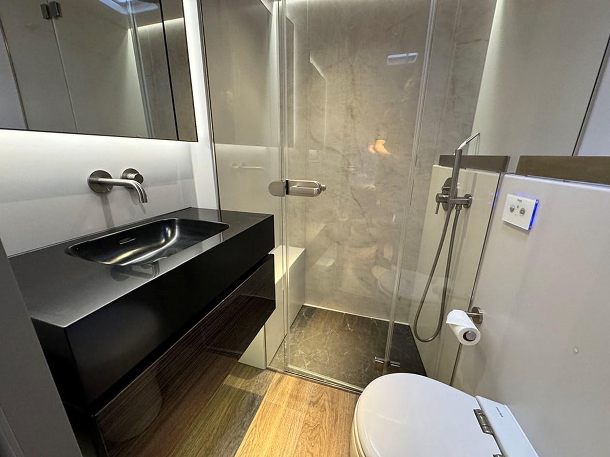 a bathroom with a glass shower aboard NAOMA Yacht for Sale