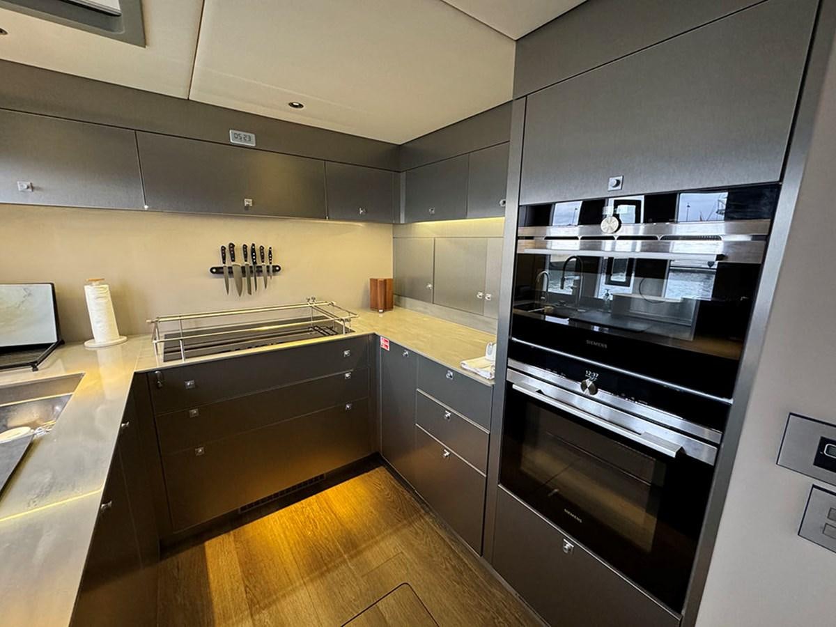 a kitchen with a stove and oven aboard NAOMA Yacht for Sale