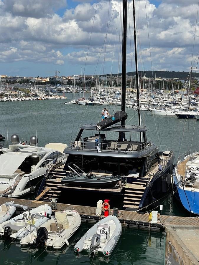 a boat docked at a pier aboard NAOMA Yacht for Sale