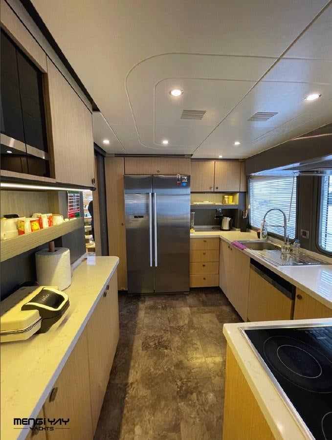 a kitchen with a stainless steel refrigerator aboard SAADET SULTAN Yacht for Sale