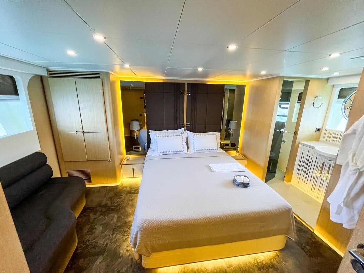 a hotel room with a bed and a couch aboard SAADET SULTAN Yacht for Sale