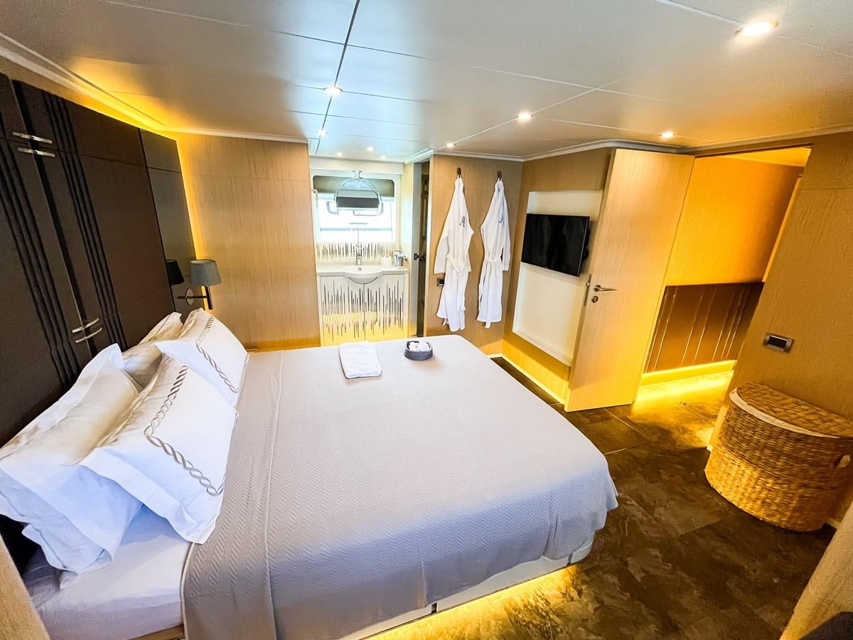 a room with a bed and a mirror aboard SAADET SULTAN Yacht for Sale
