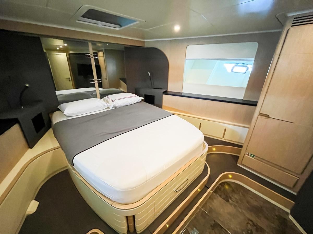 a room with a bed and a television aboard SAADET SULTAN Yacht for Sale