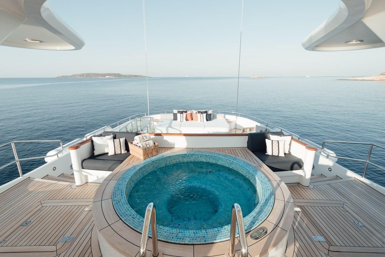 a pool on a deck overlooking a large body of water aboard HERCULES Yacht for Sale