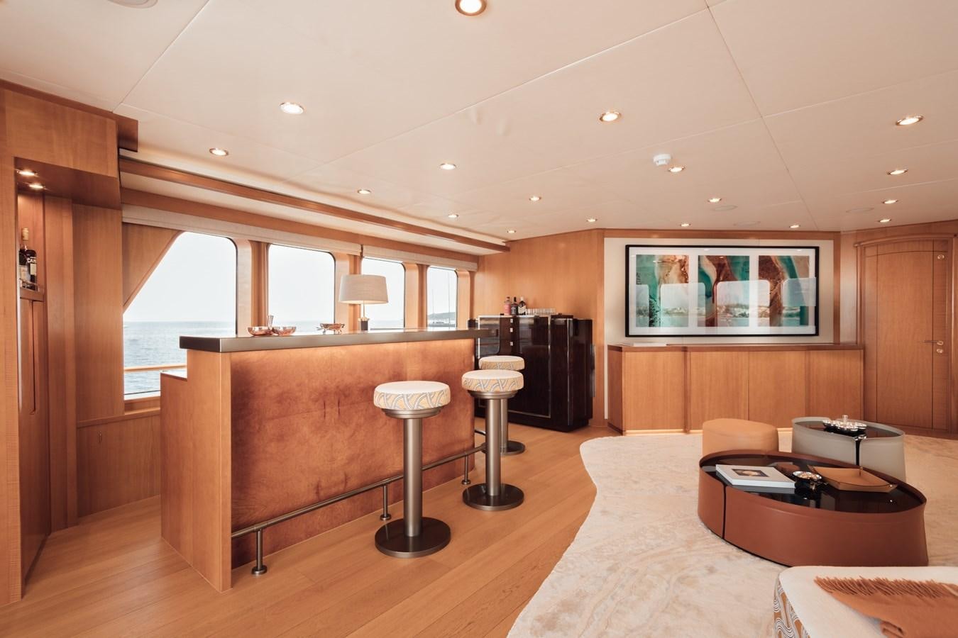 a living room with a large tv aboard HERCULES Yacht for Sale