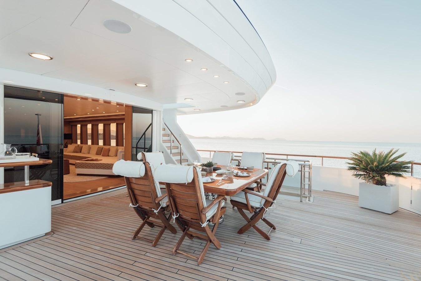 a room with a table chairs and a large window aboard HERCULES Yacht for Sale