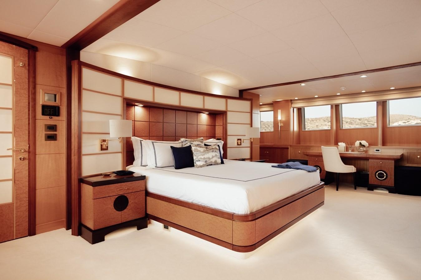 a large bedroom with a bed and desk aboard HERCULES Yacht for Sale