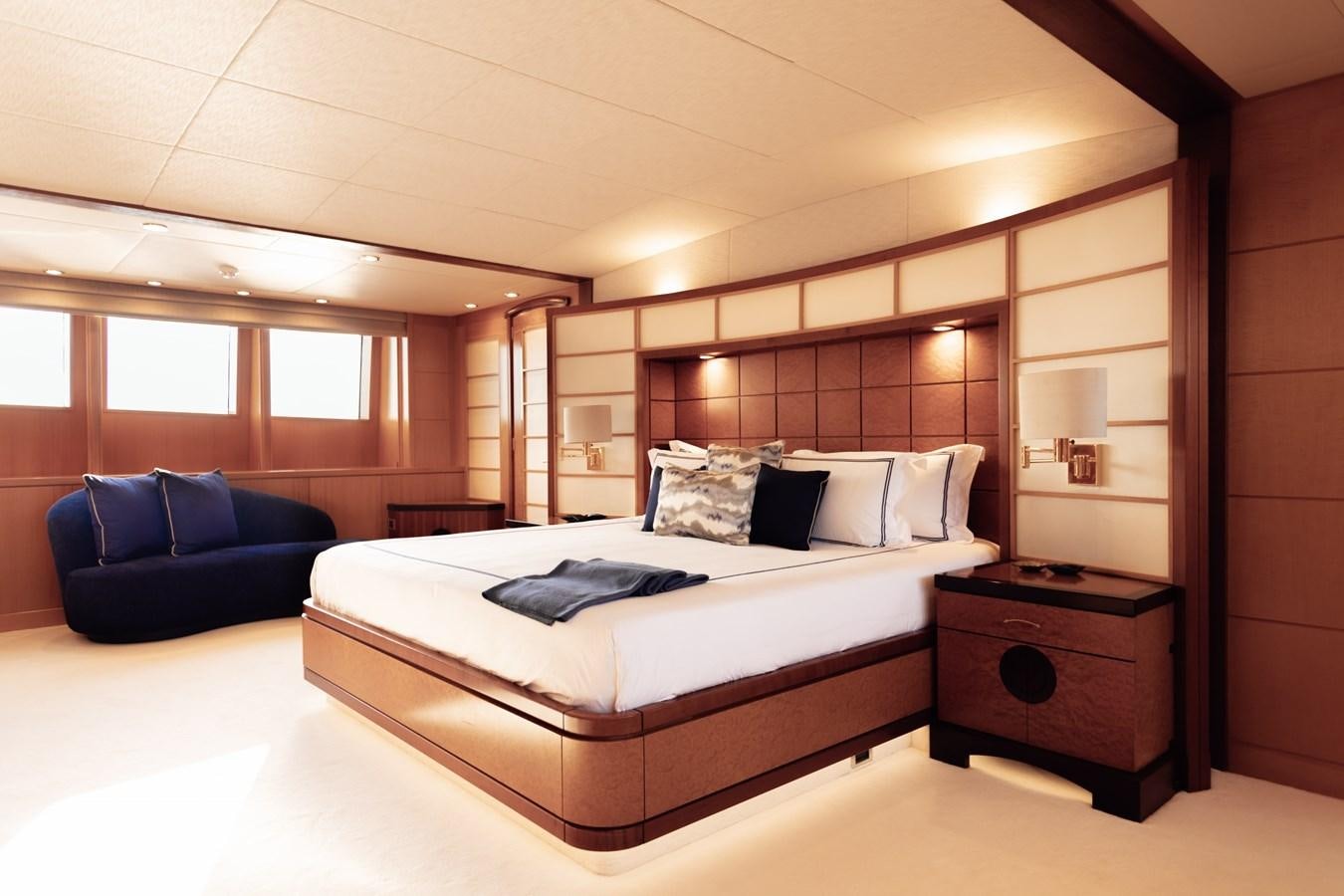 a bedroom with a bed and a couch aboard HERCULES Yacht for Sale