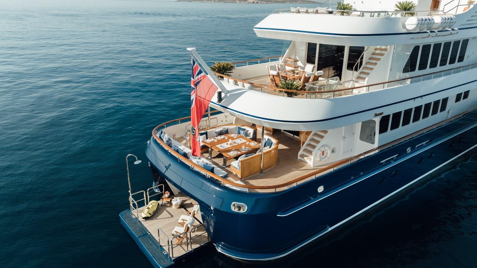 a boat with a flag on the deck aboard HERCULES Yacht for Sale