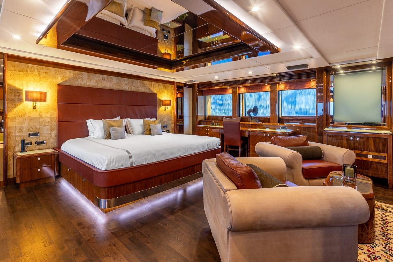a bedroom with a bed and a couch aboard IMAN Yacht for Sale