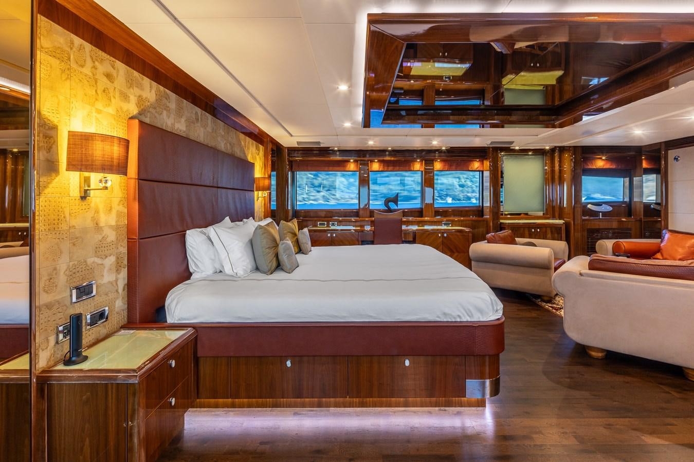 a room with a bed and a couch aboard IMAN Yacht for Sale