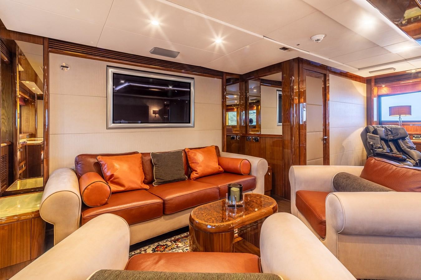 a living room with a couch and a tv aboard IMAN Yacht for Sale