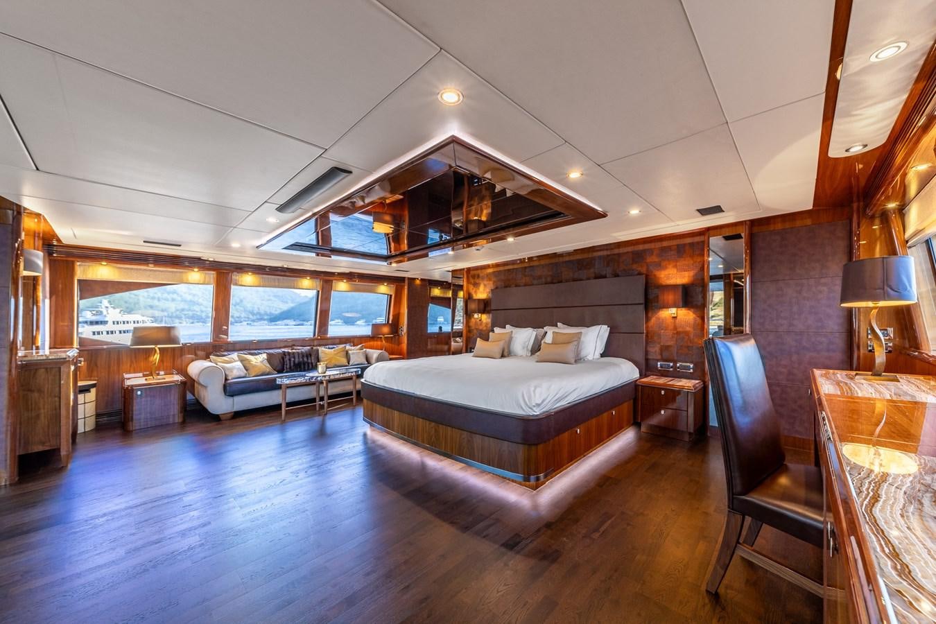 a large bedroom with a large bed aboard IMAN Yacht for Sale