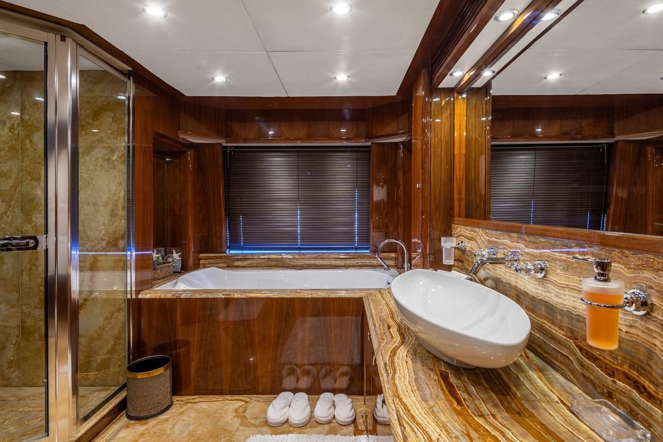 a bathroom with a tub sink and a shower unit aboard IMAN Yacht for Sale