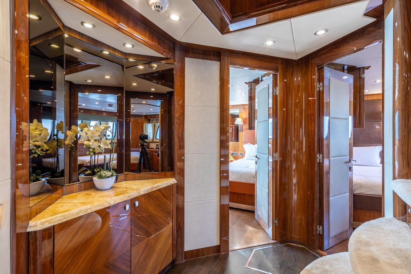 a room with a wood door and a glass wall aboard IMAN Yacht for Sale