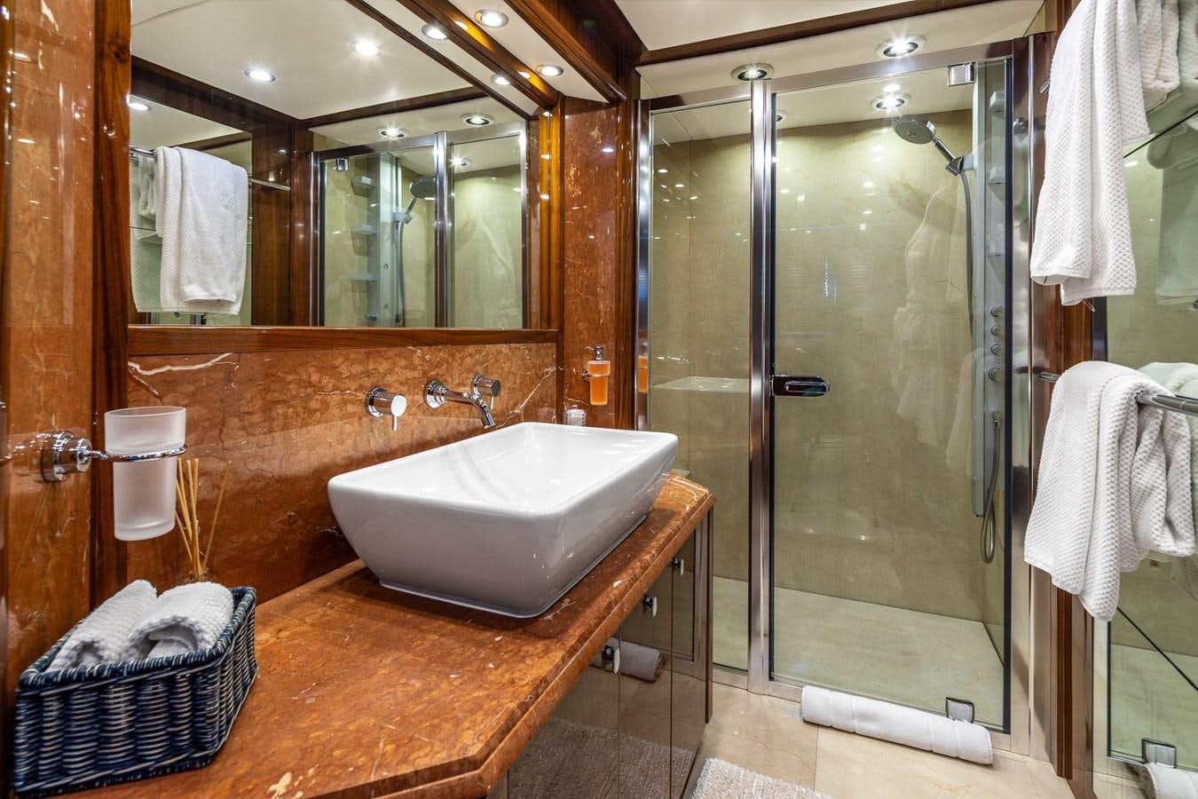 a bathroom with a glass shower aboard IMAN Yacht for Sale