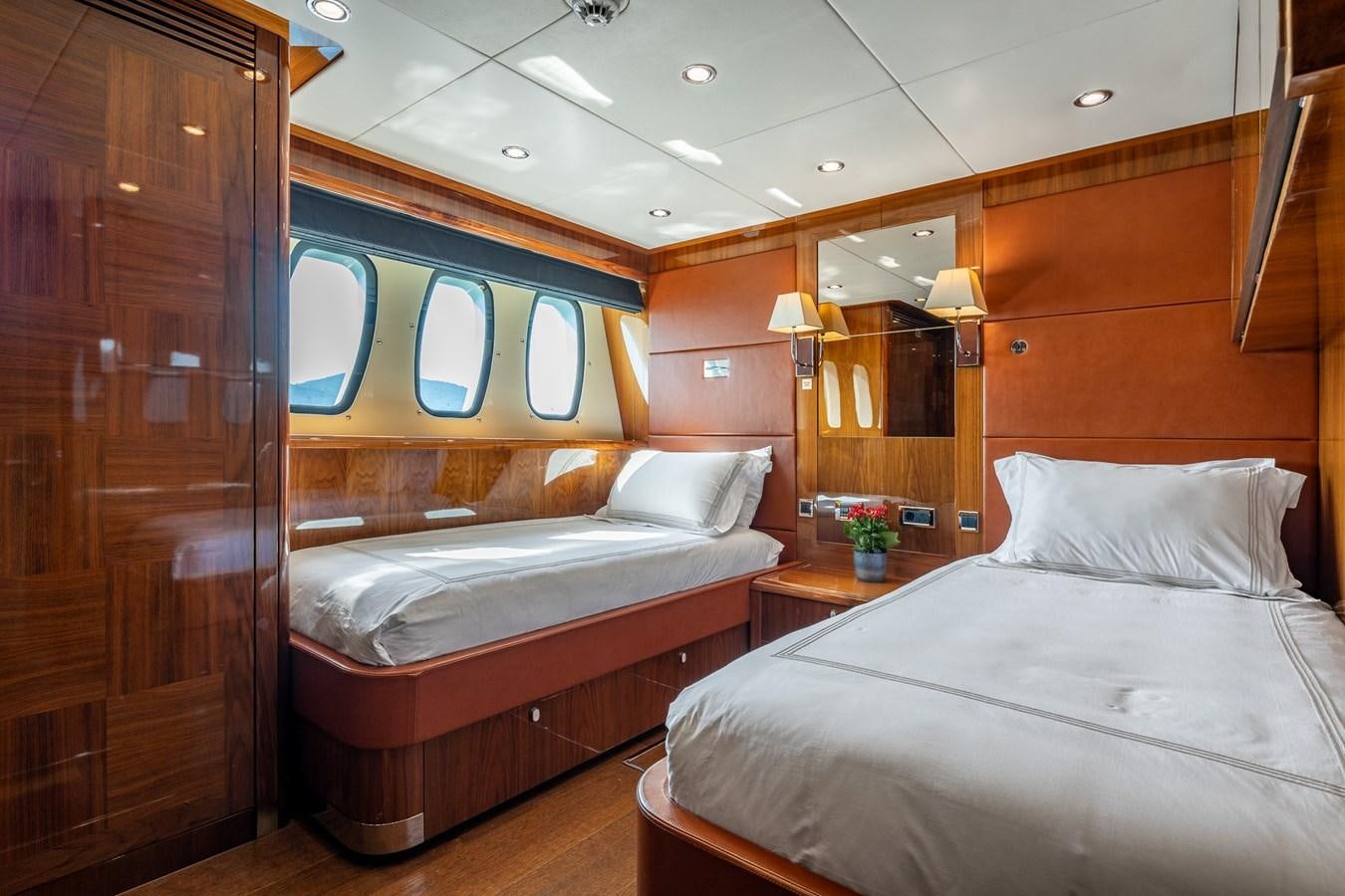 a room with a bed and a mirror aboard IMAN Yacht for Sale