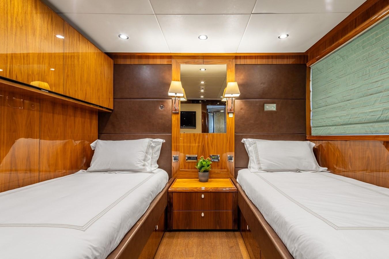 a room with two beds aboard IMAN Yacht for Sale