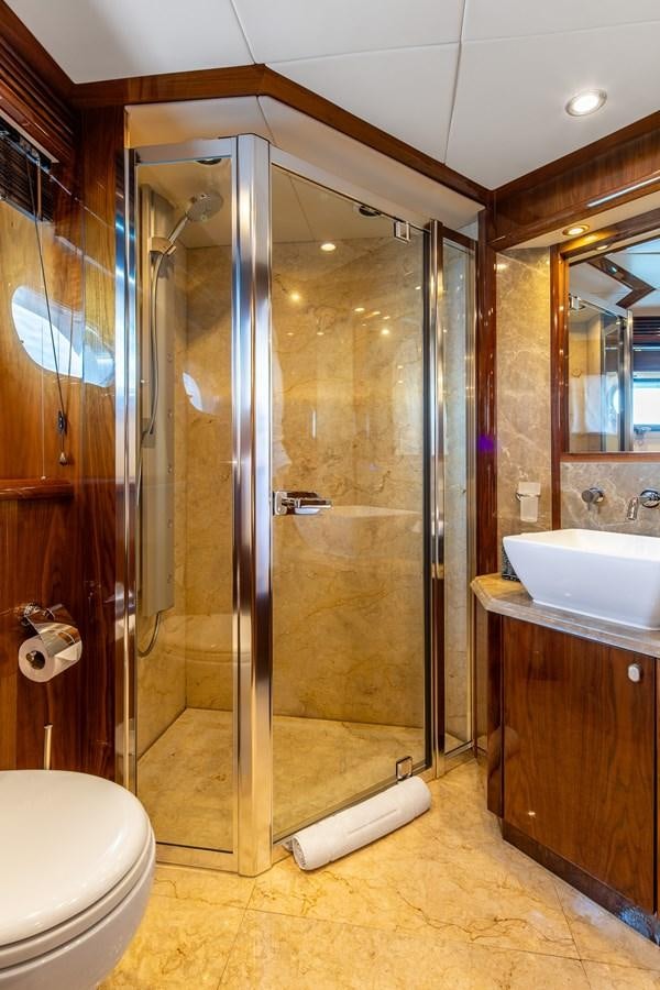 a bathroom with a shower unit and sink aboard IMAN Yacht for Sale
