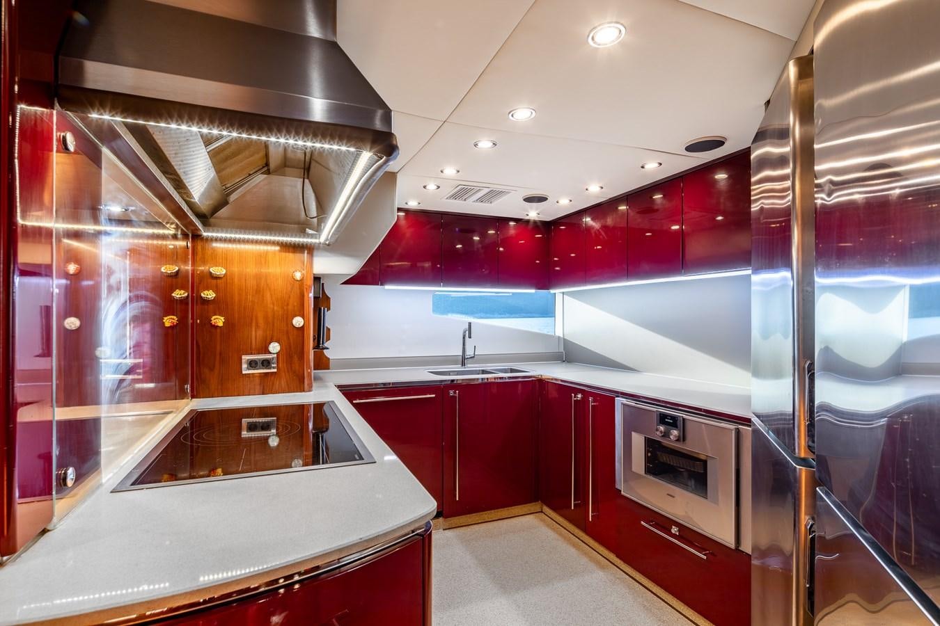 a kitchen with red cabinets aboard IMAN Yacht for Sale