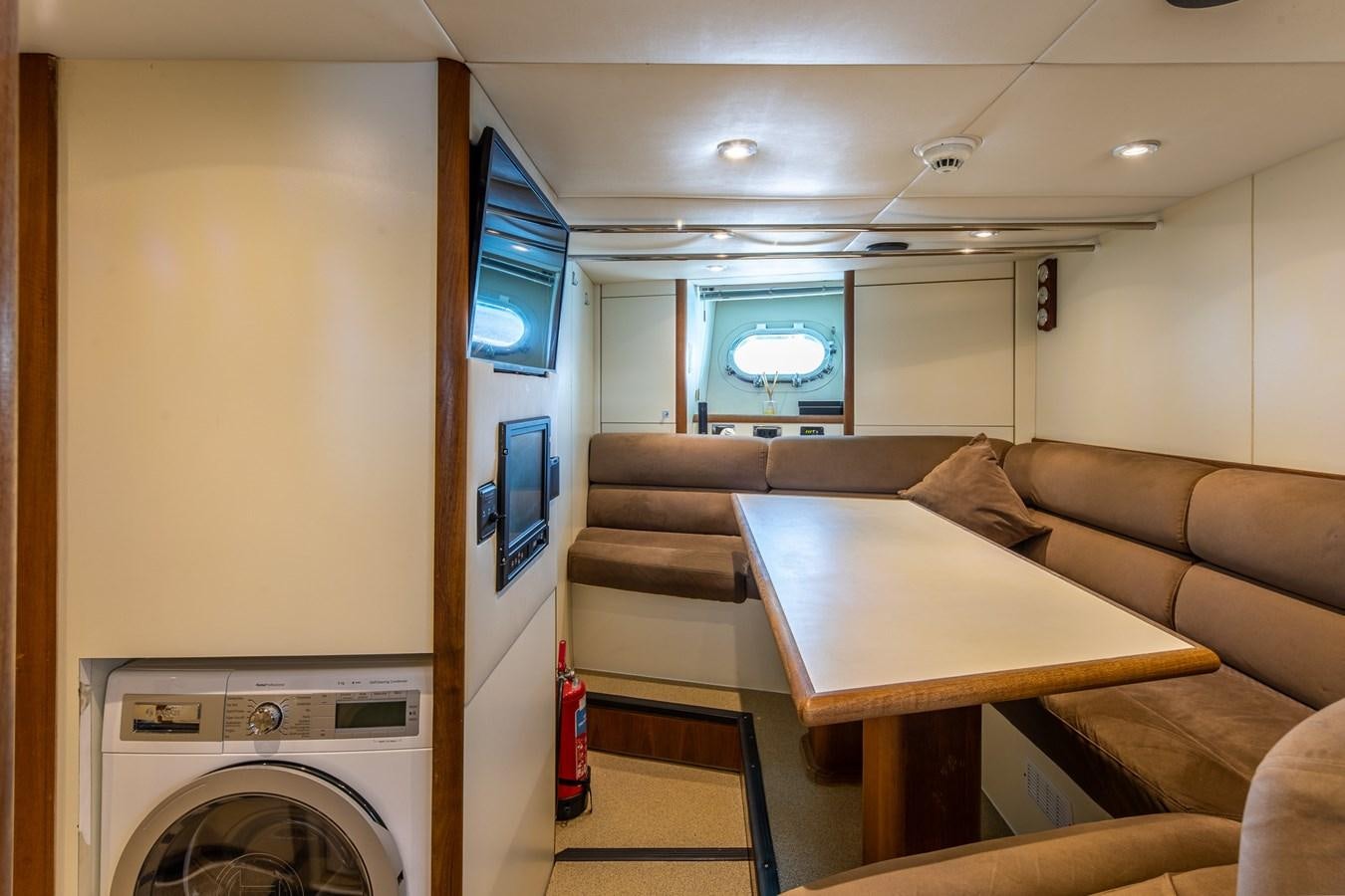 a room with a couch and a table aboard IMAN Yacht for Sale