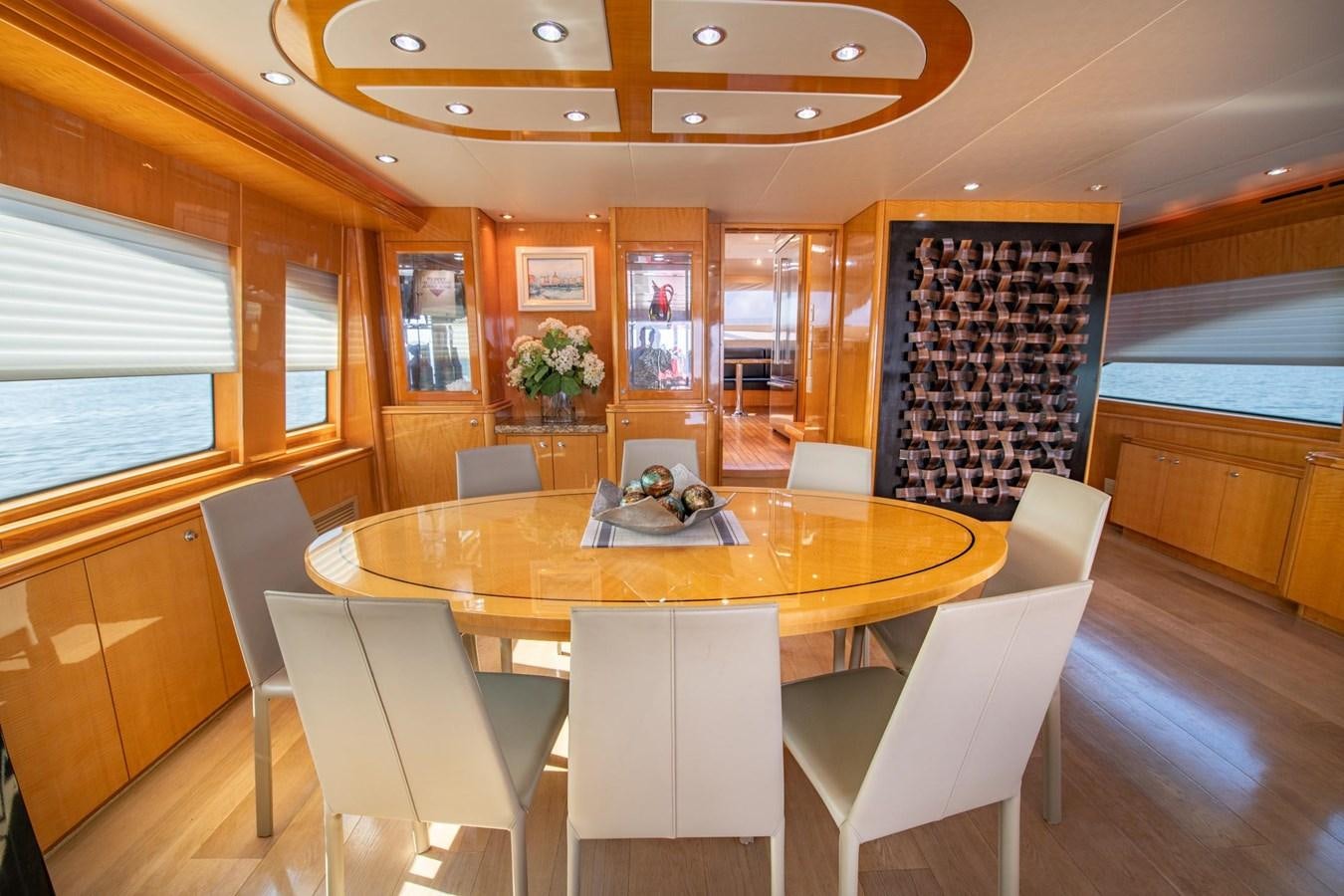 a room with a table and chairs aboard DESTINY IV Yacht for Sale