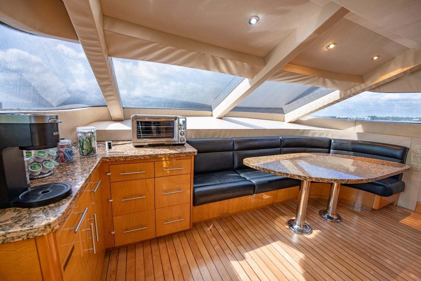 a kitchen with a table and a couch aboard DESTINY IV Yacht for Sale