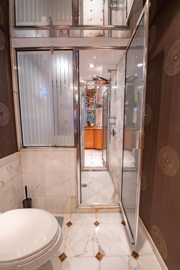 a bathroom with a glass shower aboard DESTINY IV Yacht for Sale