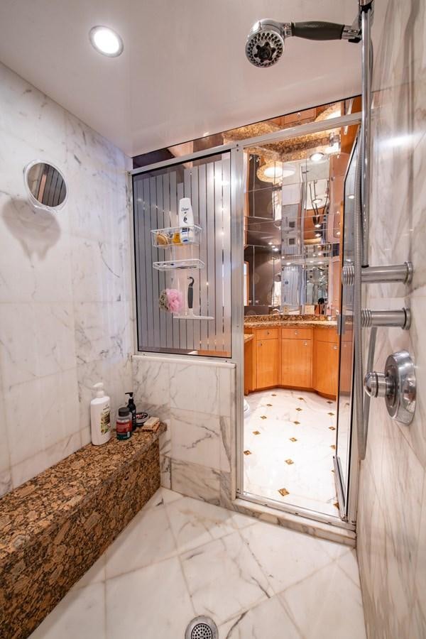 a bathroom with a glass shower aboard DESTINY IV Yacht for Sale