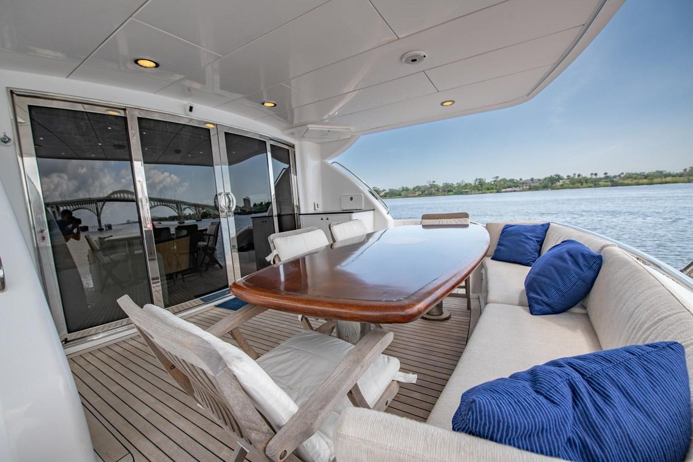 a boat with a table and chairs aboard DESTINY IV Yacht for Sale