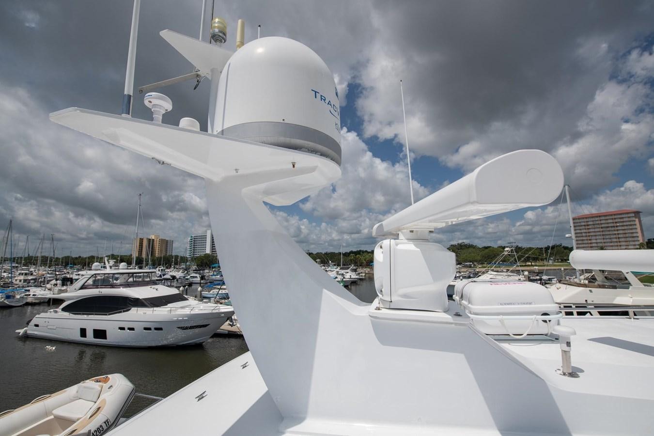 a white boat in a harbor aboard DESTINY IV Yacht for Sale