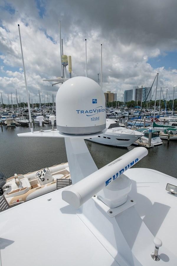 a white boat in a harbor aboard DESTINY IV Yacht for Sale