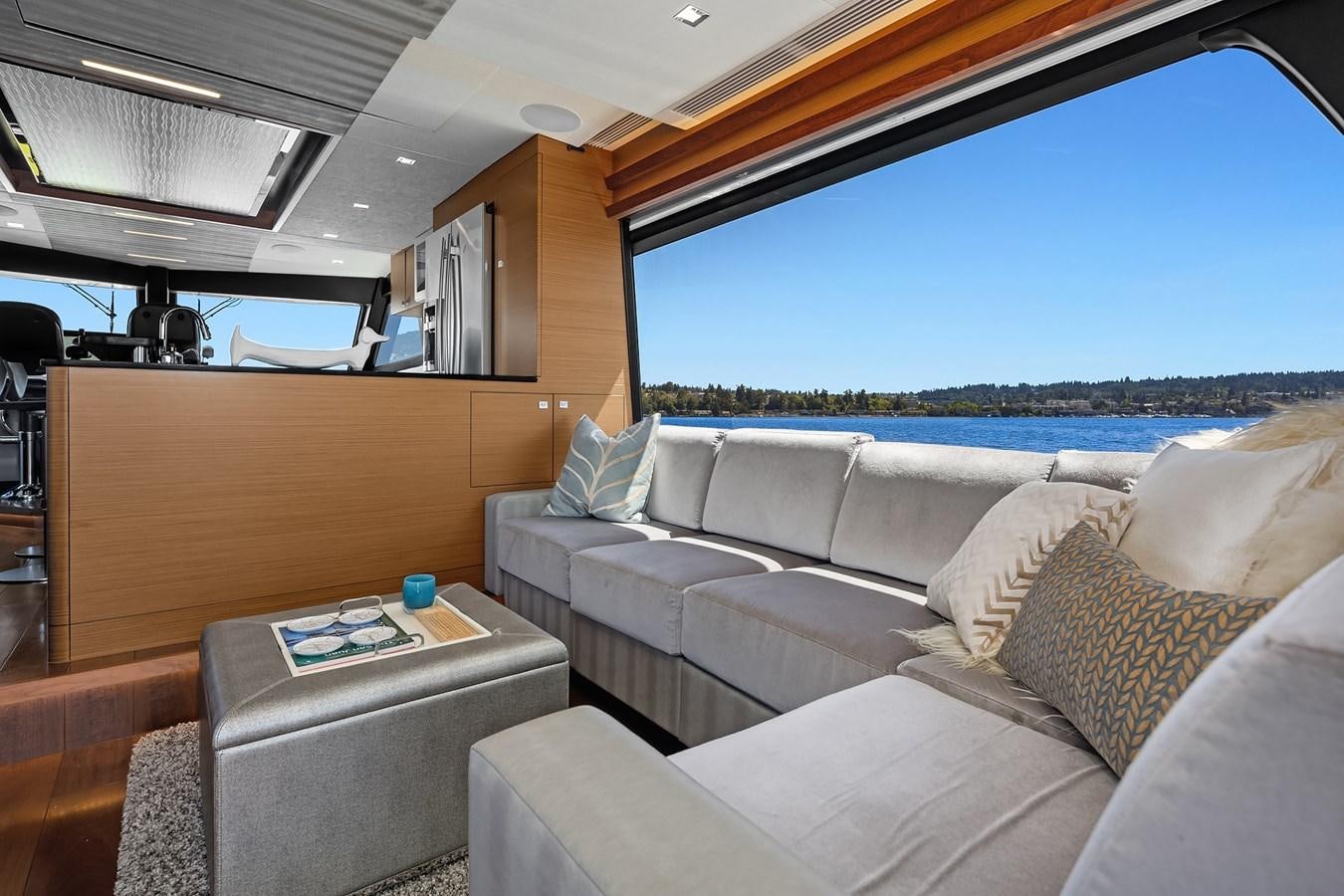 a living room with a large window aboard THRU & THRU Yacht for Sale