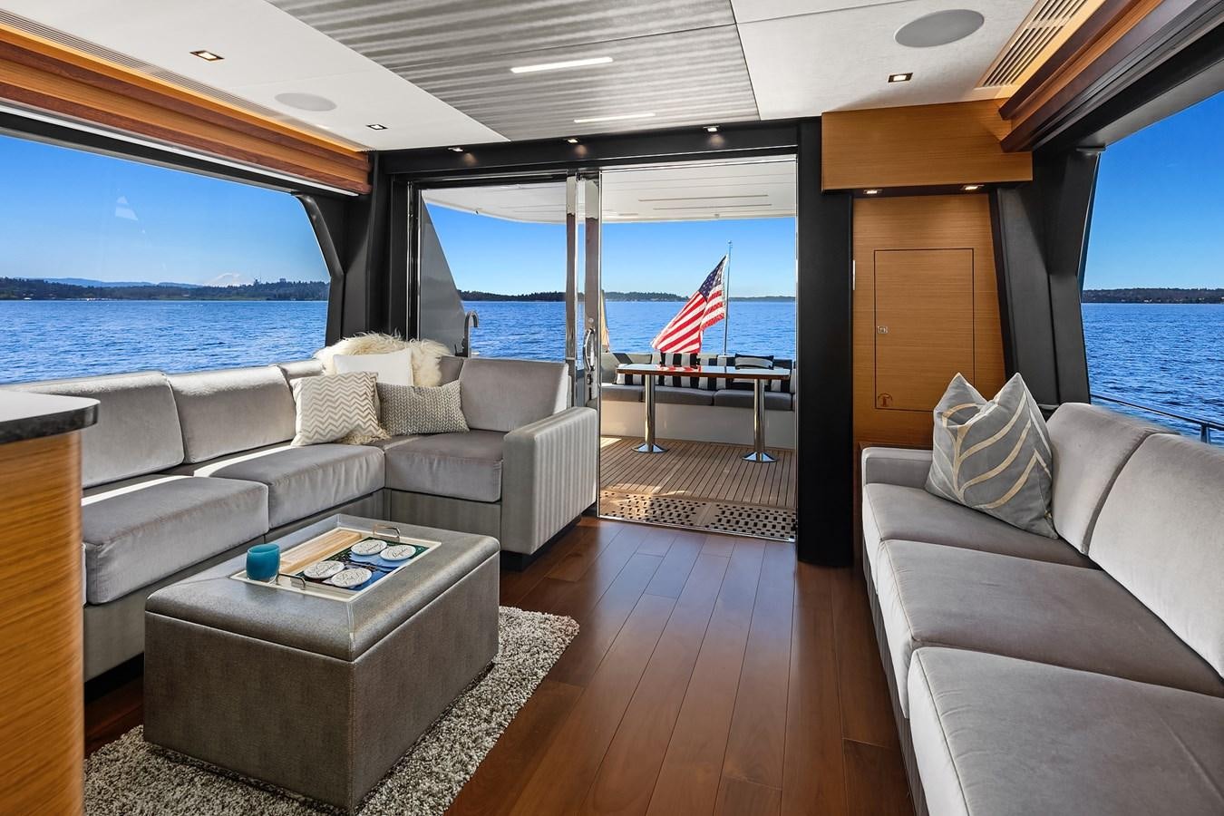 a living room with a large window aboard THRU & THRU Yacht for Sale