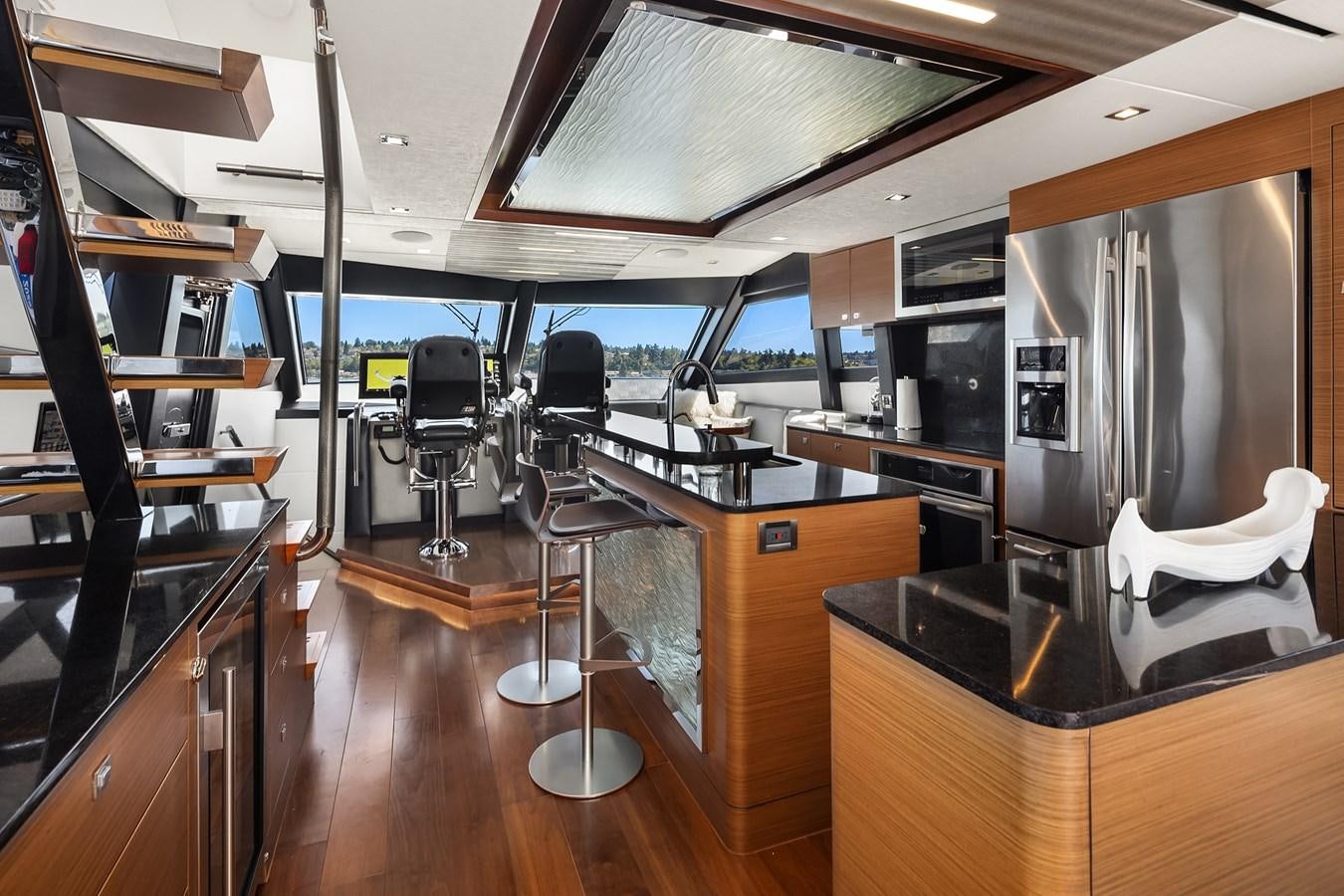 a kitchen with a large refrigerator aboard THRU & THRU Yacht for Sale