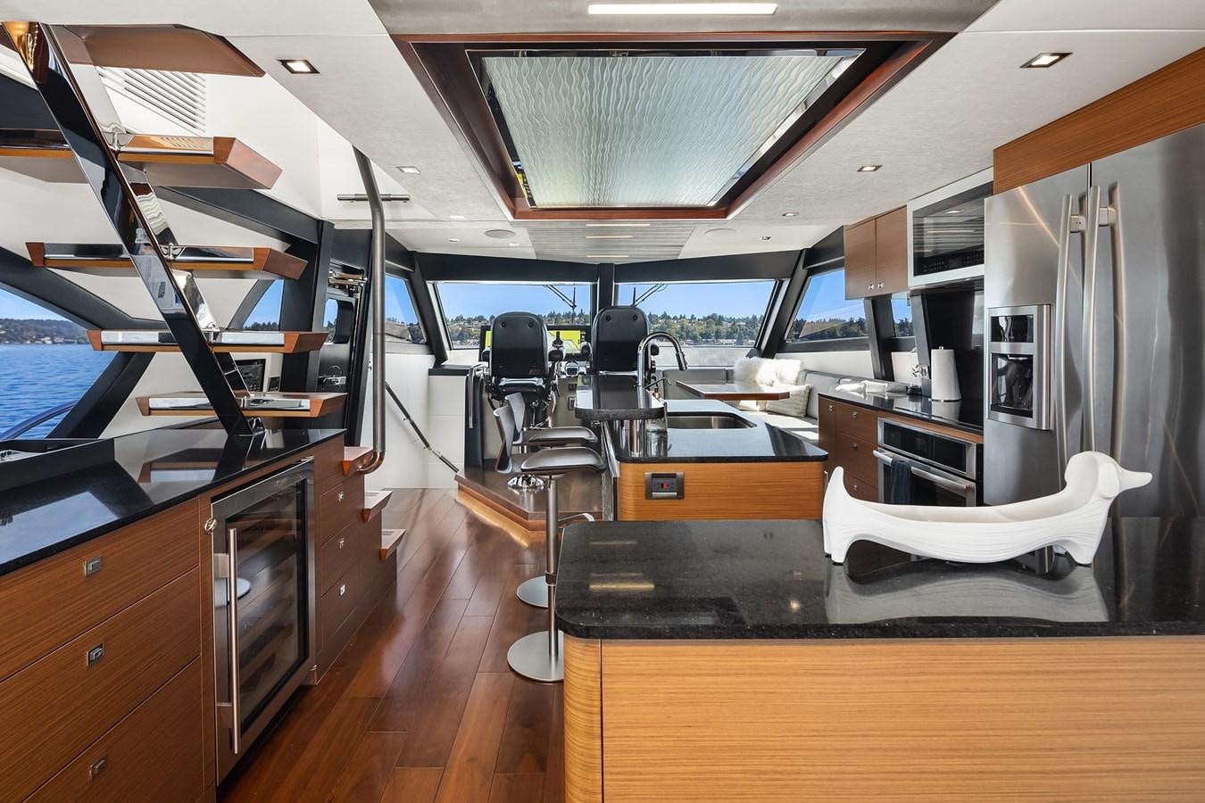 a room with a large desk and chairs aboard THRU & THRU Yacht for Sale