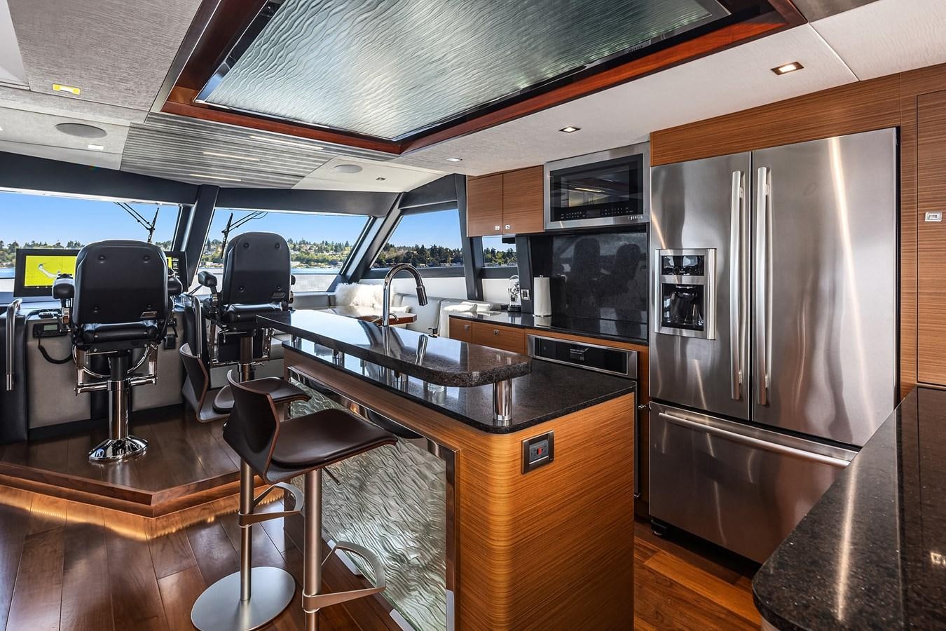 a kitchen with a large refrigerator aboard THRU & THRU Yacht for Sale