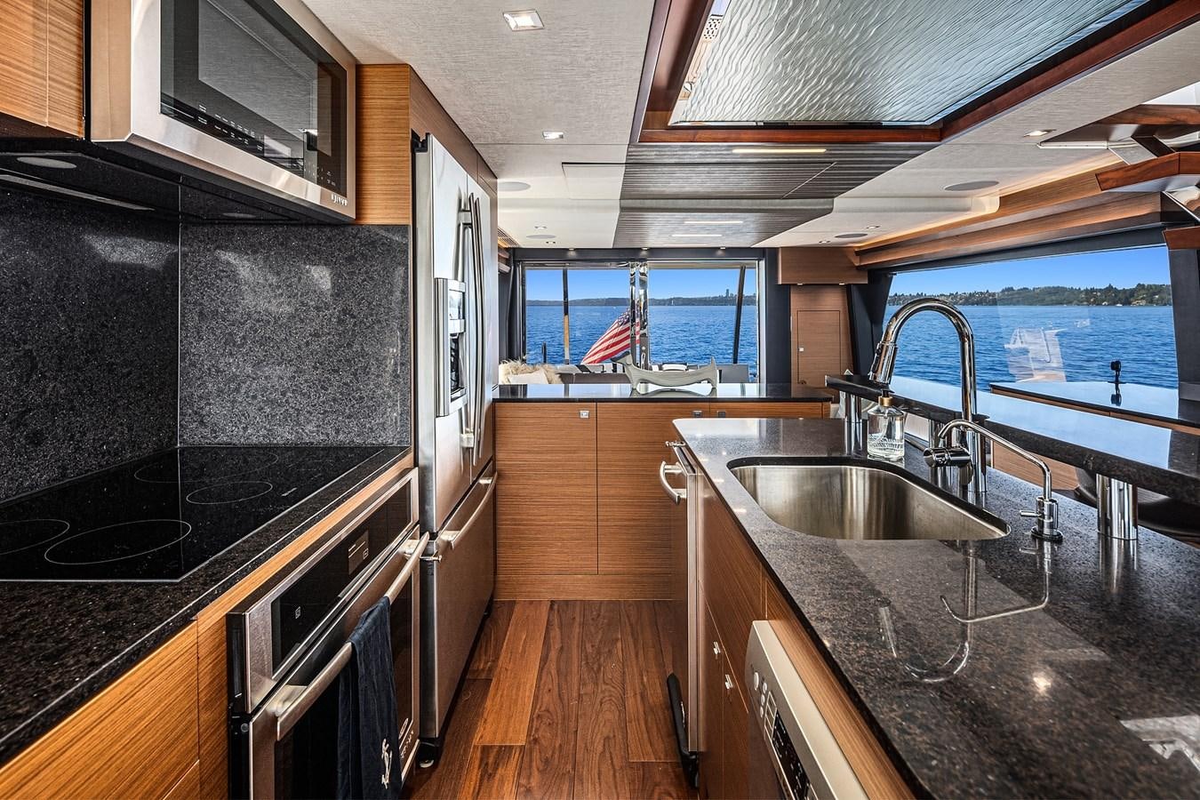 a kitchen with a large window aboard THRU & THRU Yacht for Sale