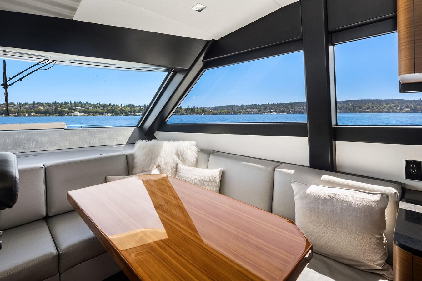 a table and chairs on a boat aboard THRU & THRU Yacht for Sale
