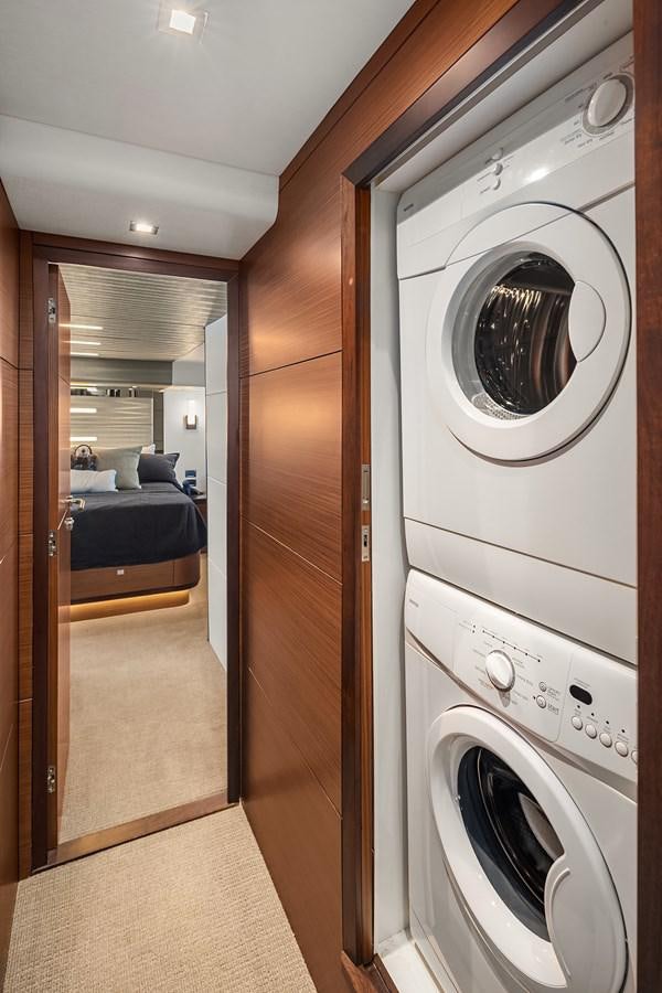 a room with a washing machine and dryer aboard THRU & THRU Yacht for Sale