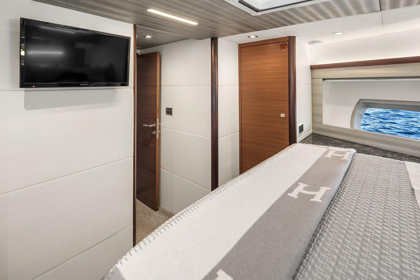a room with a tv and a bed aboard THRU & THRU Yacht for Sale