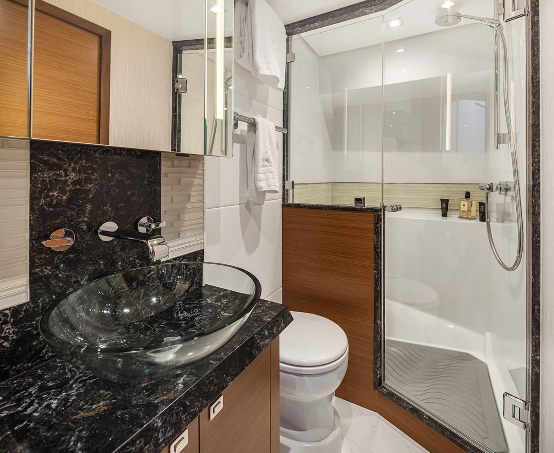 a bathroom with a glass shower aboard THRU & THRU Yacht for Sale