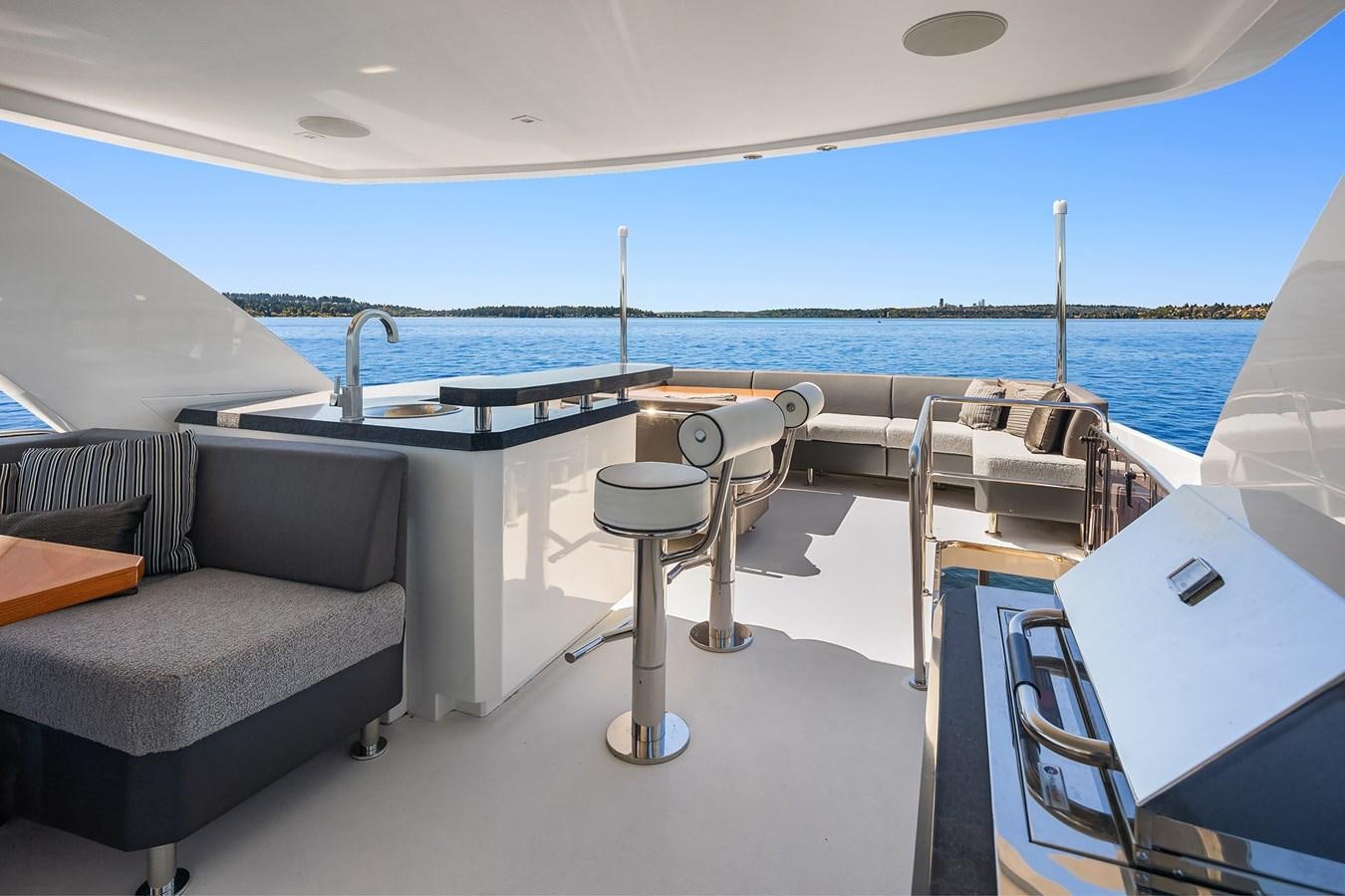 a room with a couch and a table and chairs aboard THRU & THRU Yacht for Sale