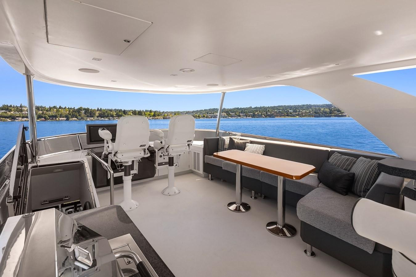 a room with a table chairs and a large pool aboard THRU & THRU Yacht for Sale