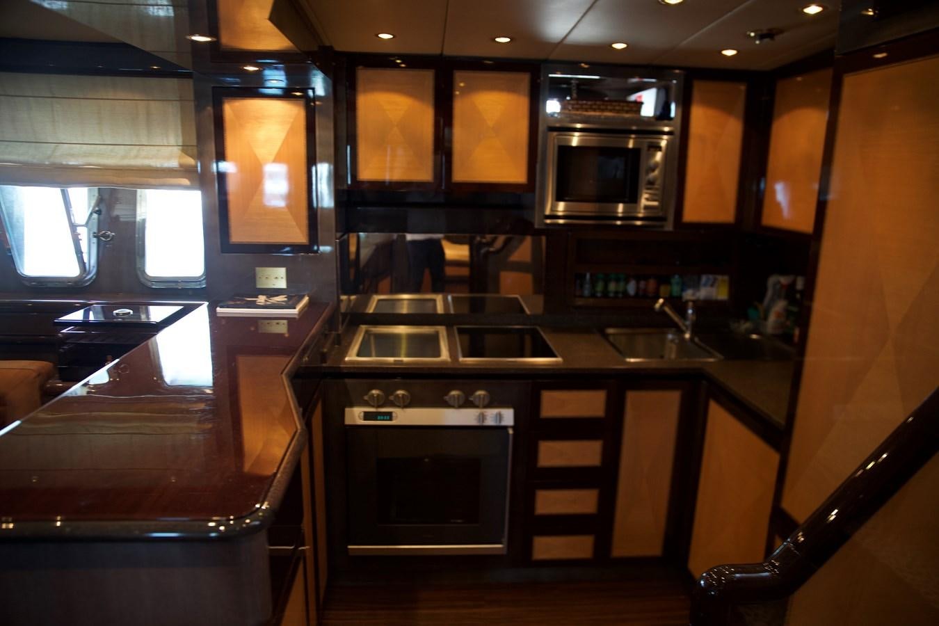 a kitchen with wooden cabinets aboard SILVER SKY Yacht for Sale