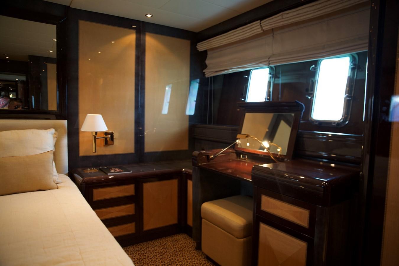 a bedroom with a bed desk and a television aboard SILVER SKY Yacht for Sale